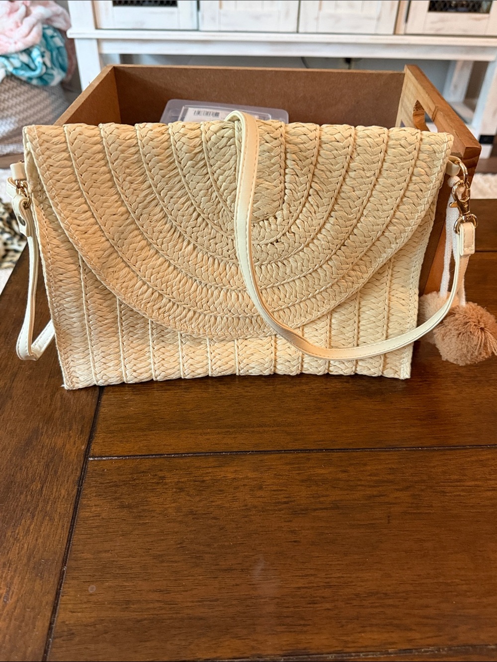 Woven Straw Crossbody Bag with Pom Accent in Cream